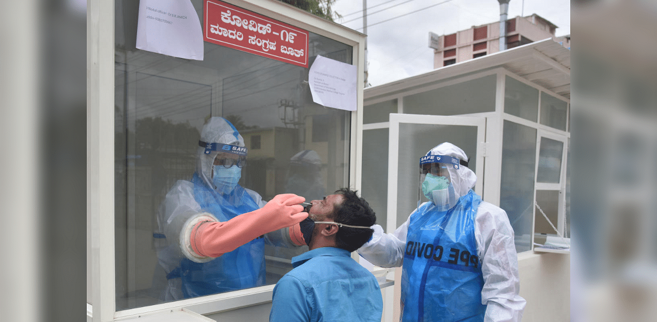 Medical staff collecting swab for Coronavirus test in Covid-19 lockdown Unlock 04 at Dr B R Ambedkar Medical College and Hospital at Kadugondanahalli in Bengaluru on Sunday, 20 September 2020. Credit: DH Photo