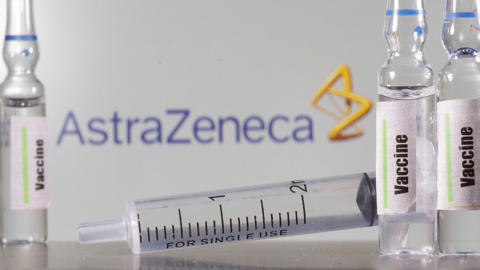 A test tube labelled with the Vaccine is seen in front of AstraZeneca logo. Credits: Reuters Photo