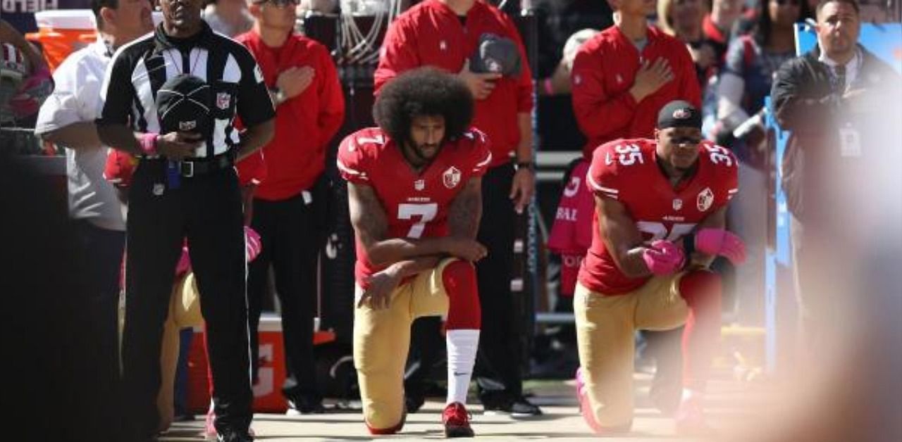 Eric Reid #35 and Colin Kaepernick #7 of the San Francisco 49ers kneel in protest during the national anthem prior to their NFL game against the Tampa Bay Buccaneers at Levi's Stadium in Santa Clara, California. Credit: AFP Photo
