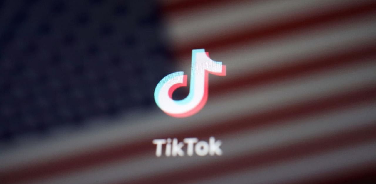 A reflection of the US flag is seen on the sign of the TikTok app.Credit: Reuters