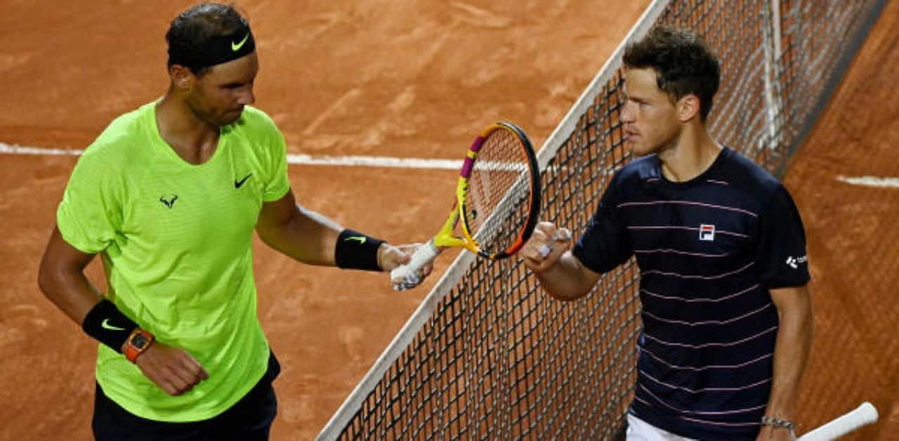 Argentina's Diego Schwartzman with Spain's Rafael Nadal after winning their quarter final match. Credit: Reuters Photo