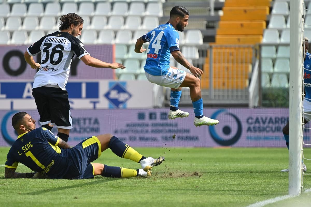 Napoli's Italian forward Lorenzo (C) jumps as he scores his team's second goal past Parma's Italian goalkeeper Luigi Sepe (L) during the Italian Serie A football match Parma vs Napoli. Credit: AFP