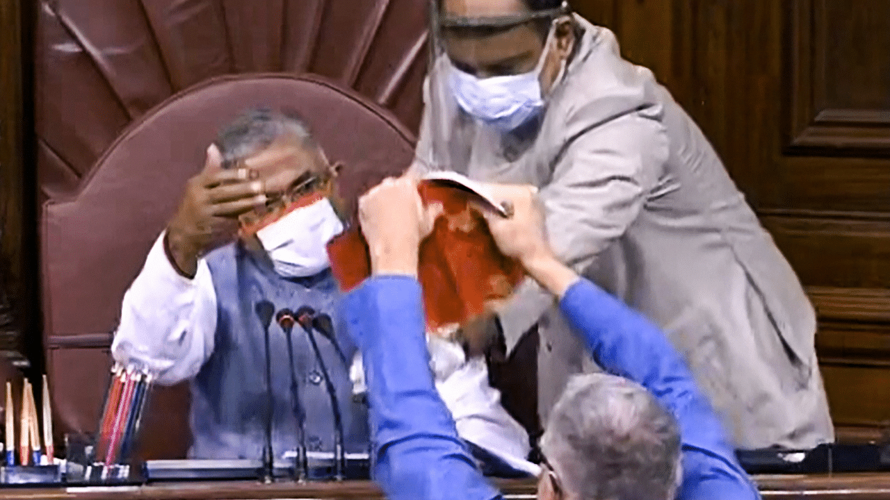 TMC MP Derek O'Brien attempts to tear the rule book as ruckus erupts in the Rajya Sabha over agriculture related bills, during the ongoing Monsoon Session. Credits: PTI Photo