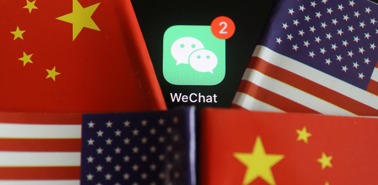 The messenger app WeChat is seen among US and China flags. Credit: Reuters Photo