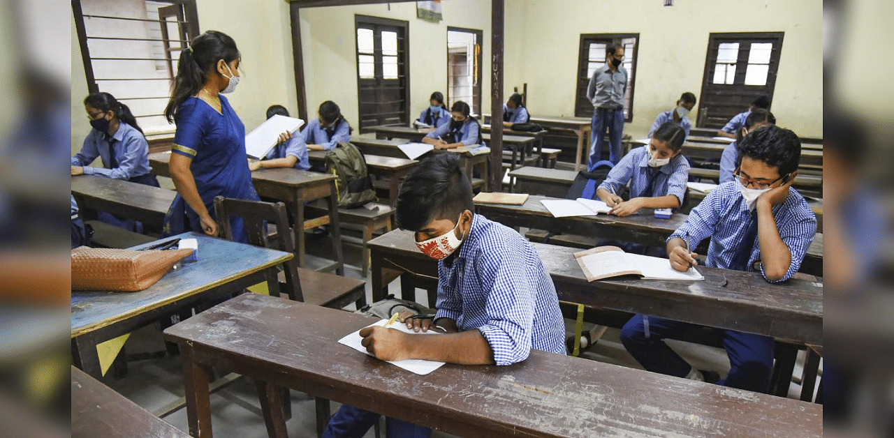 Students maintain social distancing as they attend a class, after schools and colleges re-opened in Assam during Unlock 4, at Angelika Higher Secondary School in Guwahati, Monday, Sept. 21, 2020. Credit: PTI Photo