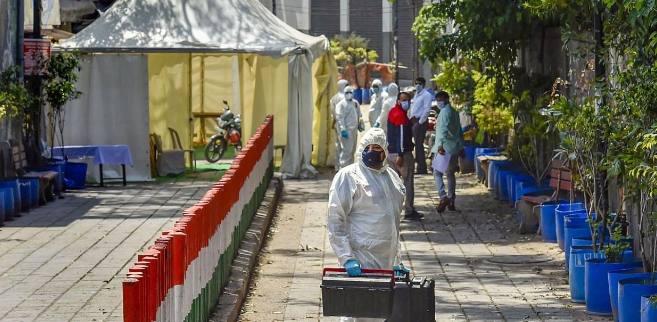 Forensic officials arrive at  to conduct an investigation, during the nationwide lockdown to curb the spread of coronavirus. Credit: PTI