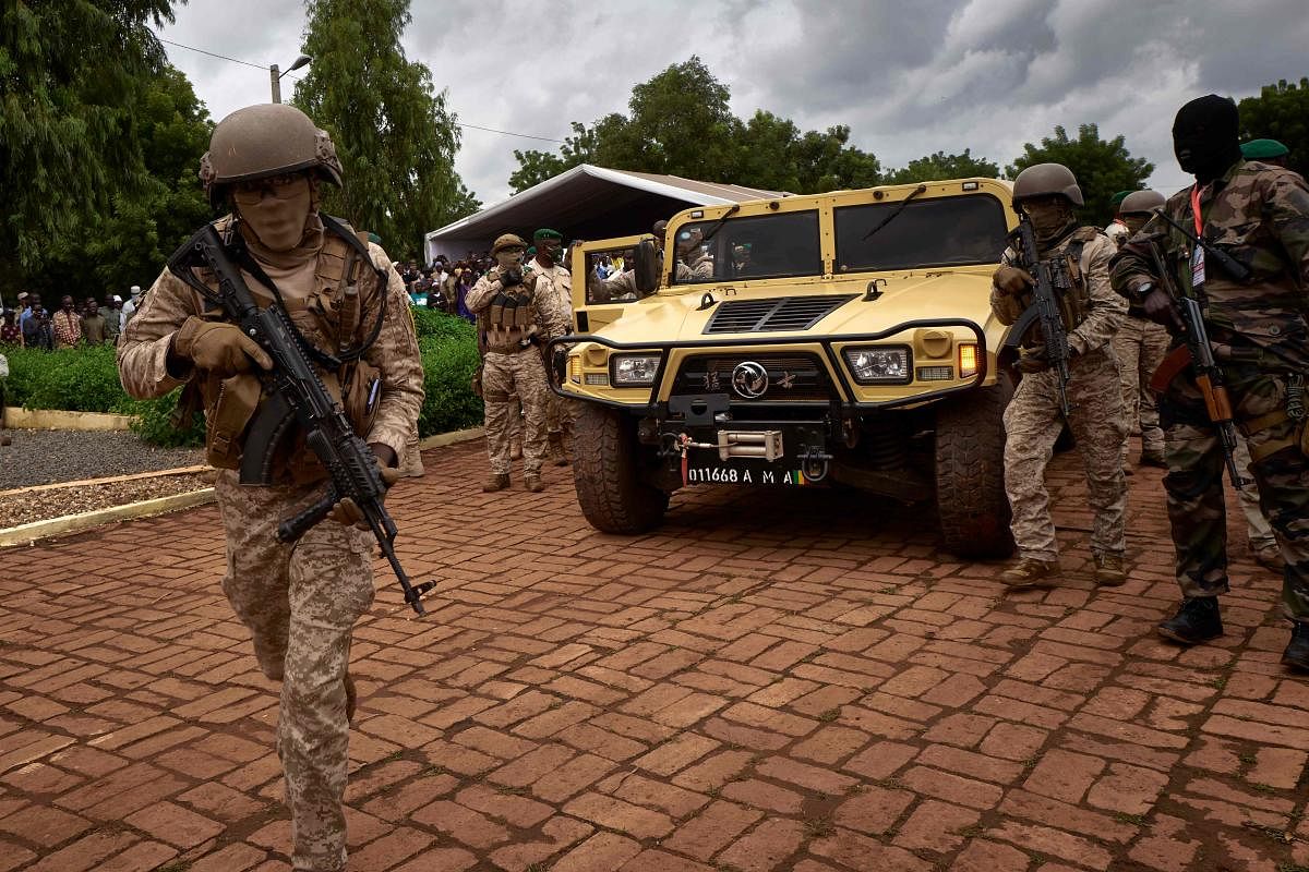 The armoured vehicle of Colonel Assimi Goita (C), president of the CNSP (National Committee for the Salvation of the People), arrives at the funeral of former Mali President General Moussa Traore in Bamako. Credit: AFP file photo