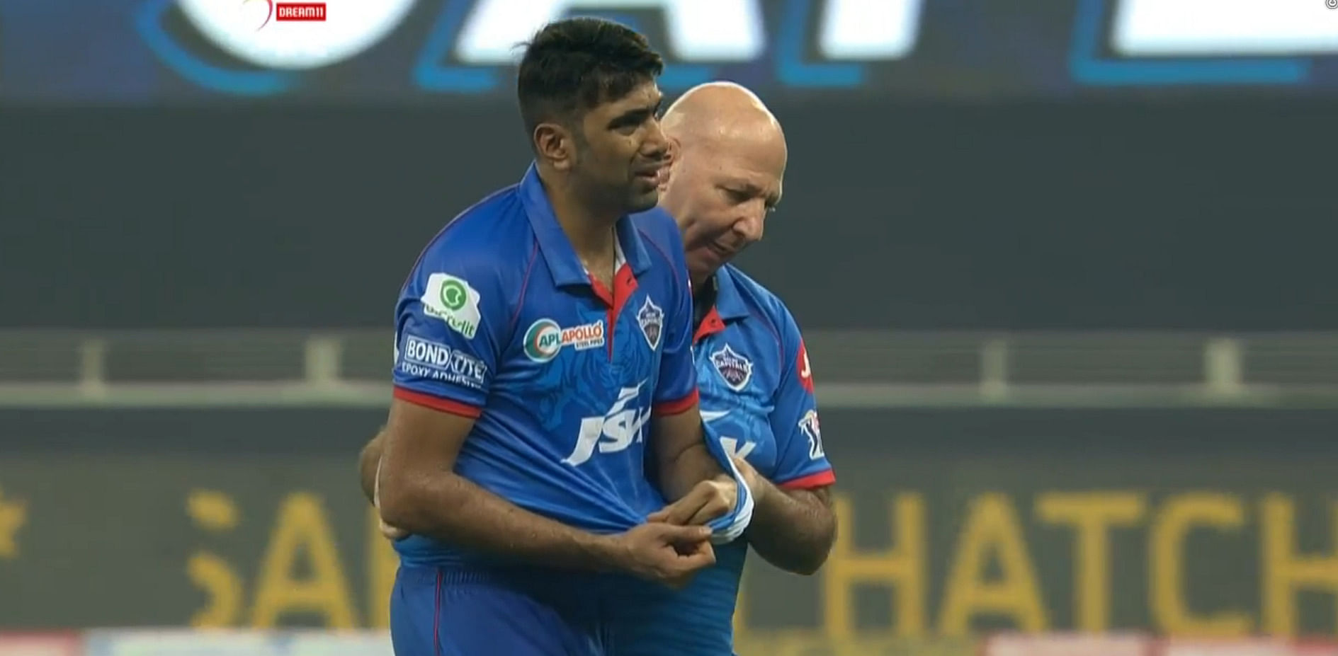 Writhing in pain, Ashwin's jersey became a temporary sling as he left the field along with Capitals' physio Patrick Farhart. Credit: iplt20.com