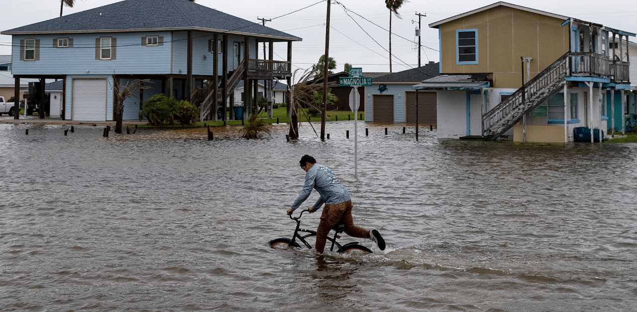 A boy rides his bike down South Magnolia Street in Rockport, Texas, as Tropical Storm Beta approaches. Credit: AP Photo