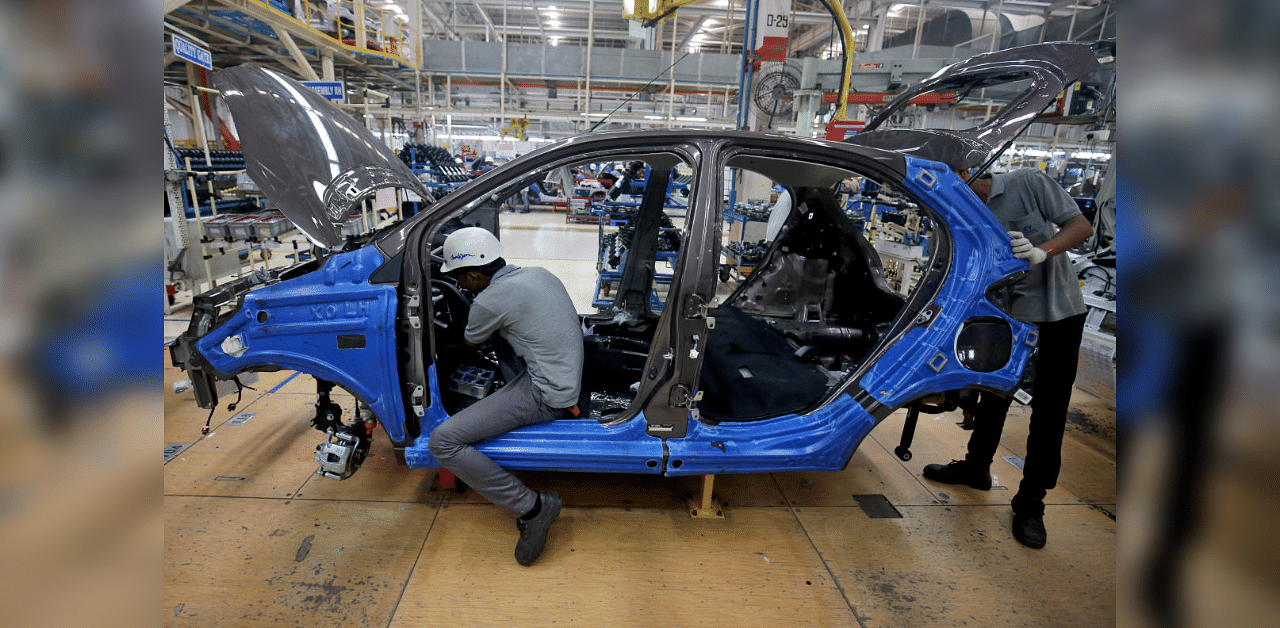 Workers assemble a Tata Tiago car. Credit: Reuters