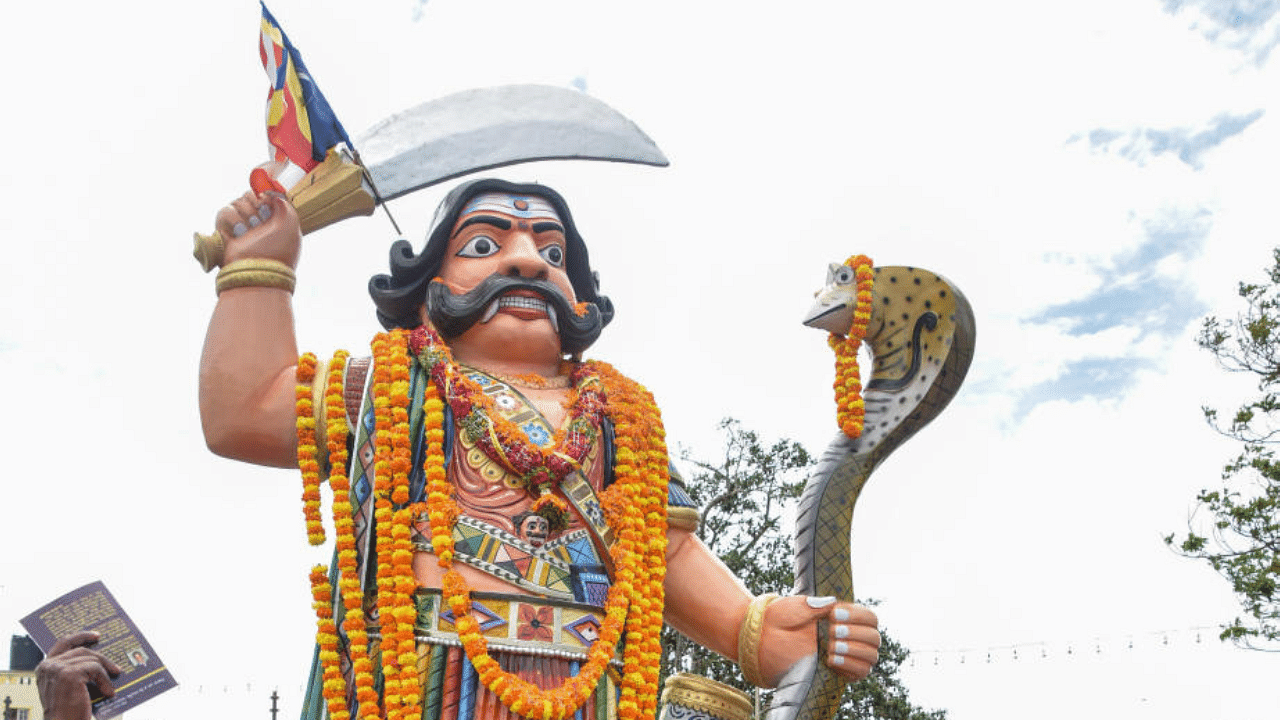 Members of Dalit Welfare Trust and University of Mysore Research Students’ Federation pay tributes to the statue of Mahishasura as part of Mahisha Dasara, atop the Chamundi Hill in 2017. DH File Photo