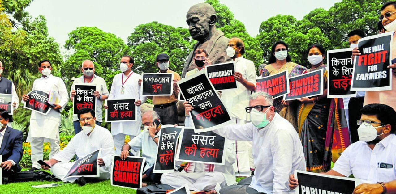 Protesting MP in front of Mahatma Gandhi's Statue. Credit: PTI Photo