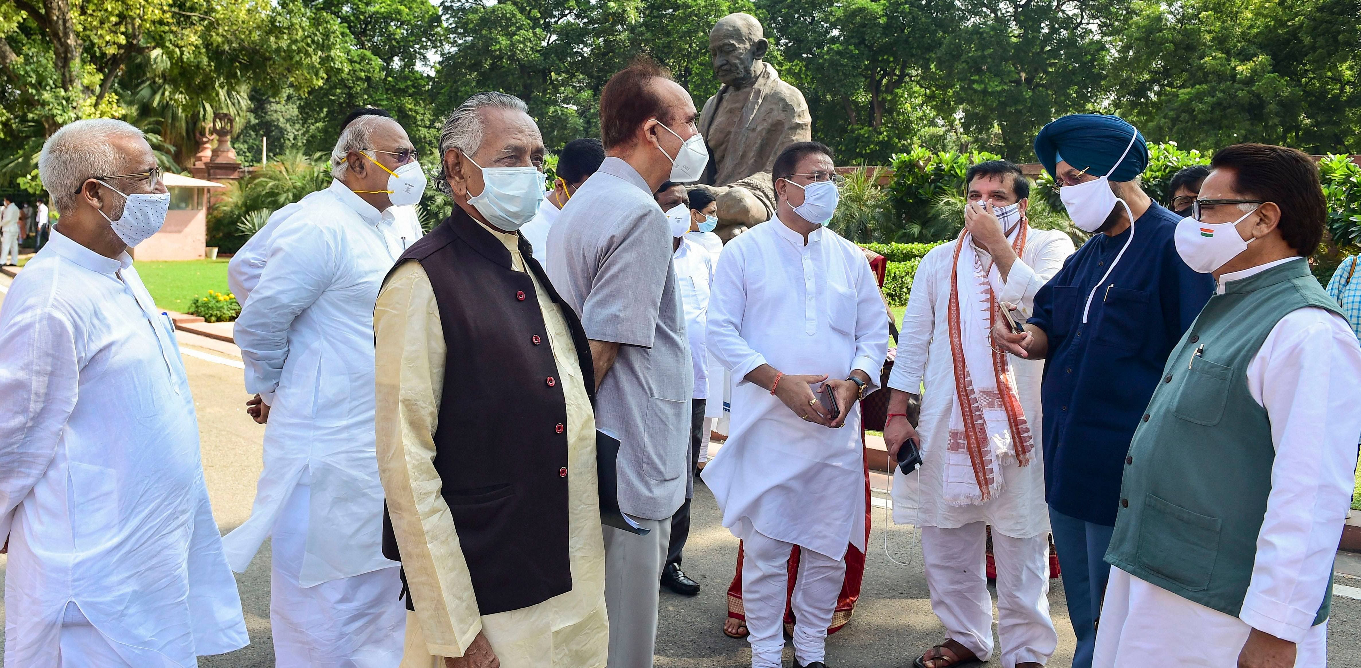 Congress MP Ghulam Nabi Azad and other opposition MPs stage a walkout from the Rajya Sabha, demanding suspension of 8 lawmakers be revoked, during the ongoing Monsoon Session of Parliament, at Parliament House in New Delhi. Credit: PTI