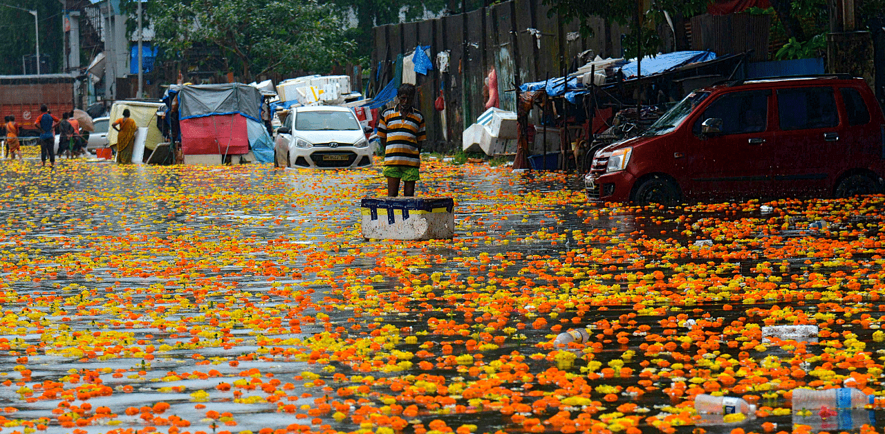  A vendor stands in a flooded flower market following heavy monsoon rains in Mumbai. Credit: AFP Photo