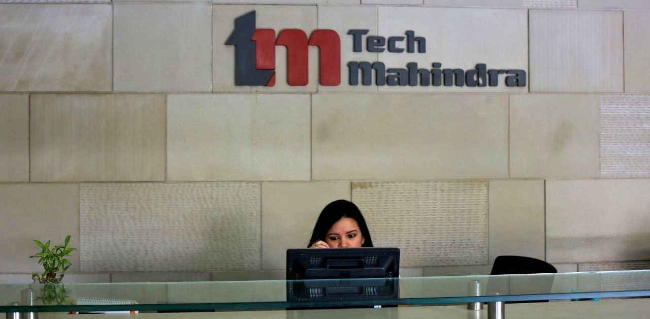 An employee sits at the front desk inside Tech Mahindra office building in Noida. Credit: Reuters