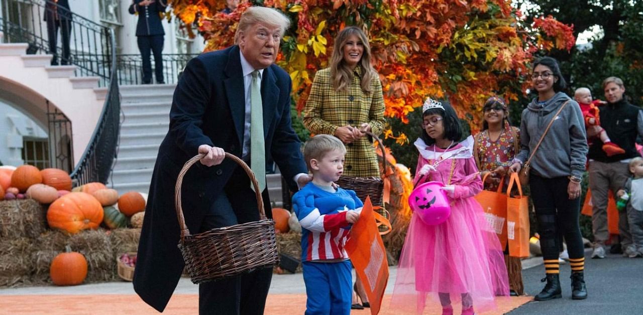 US President Donald Trump and First Lady Melania Trump give out candy to children at a Halloween celebration at the White House in Washington in 2018. Credit: AFP