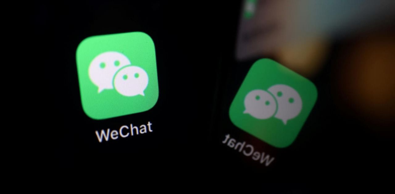 The sign of the WeChat app is seen reflected on a mobile phone. Credit: Reuters