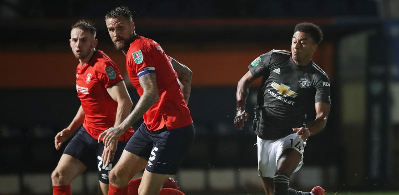 Manchester United's Jesse Lingard in action with Luton Town's Sonny Bradley. Credit: Reuters