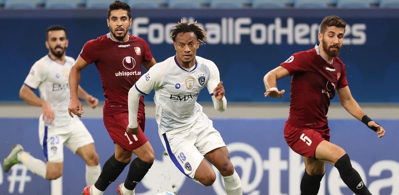 Al-Hilal's midfielder Andre Carrillo (C) dribbles past Shahr Khdro's defender Farshad Faraji. Credit: AFP