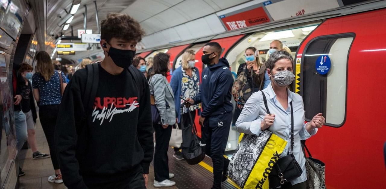 Commuters wearing a face mask or covering due to the Covid-19 pandemic. Credit: AFP
