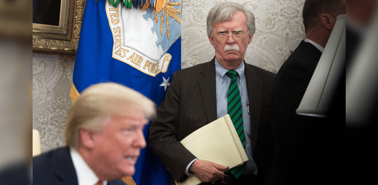 National Security Adviser John Bolton stands alongside US President Donald Trump. Credit: AFP Photo