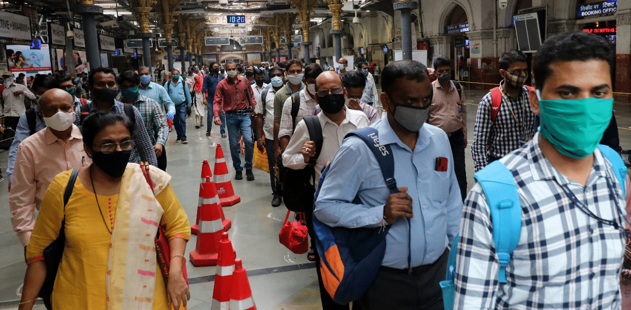 People wearing protective face masks leave the Chhatrapati Shivaji Terminus railway station. Credit: Reuters Photo