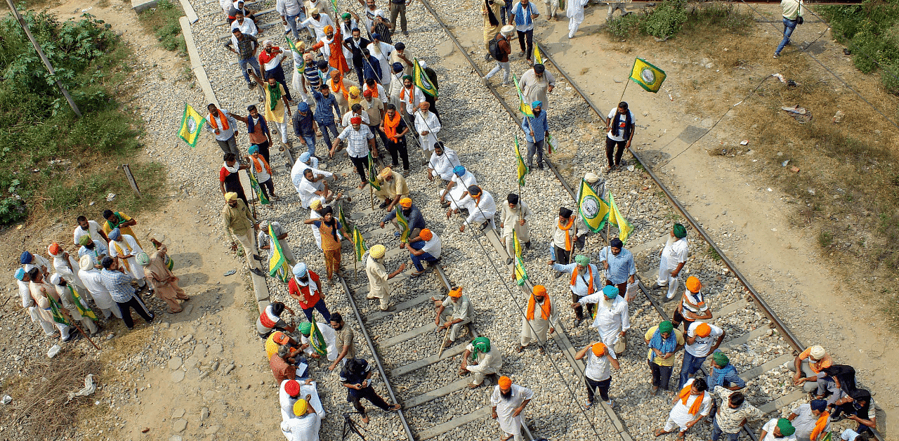 Members of various farmer organisations block railway tracks during a protest against the central government over agriculture related ordinances, at Nabha in Patiala. Credit: PTI Photo