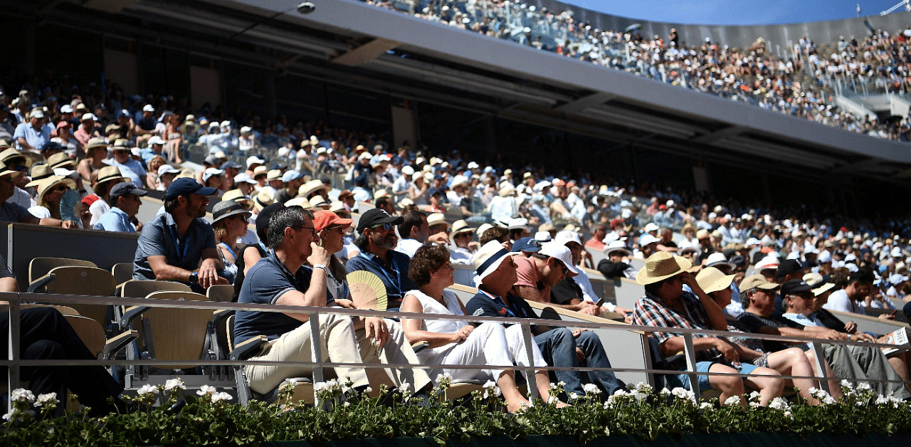  People wearing a hat, attend a tennis match on day seven of The Roland Garros 2019 French Open tennis tournament in Paris. Credit: AFP Photo
