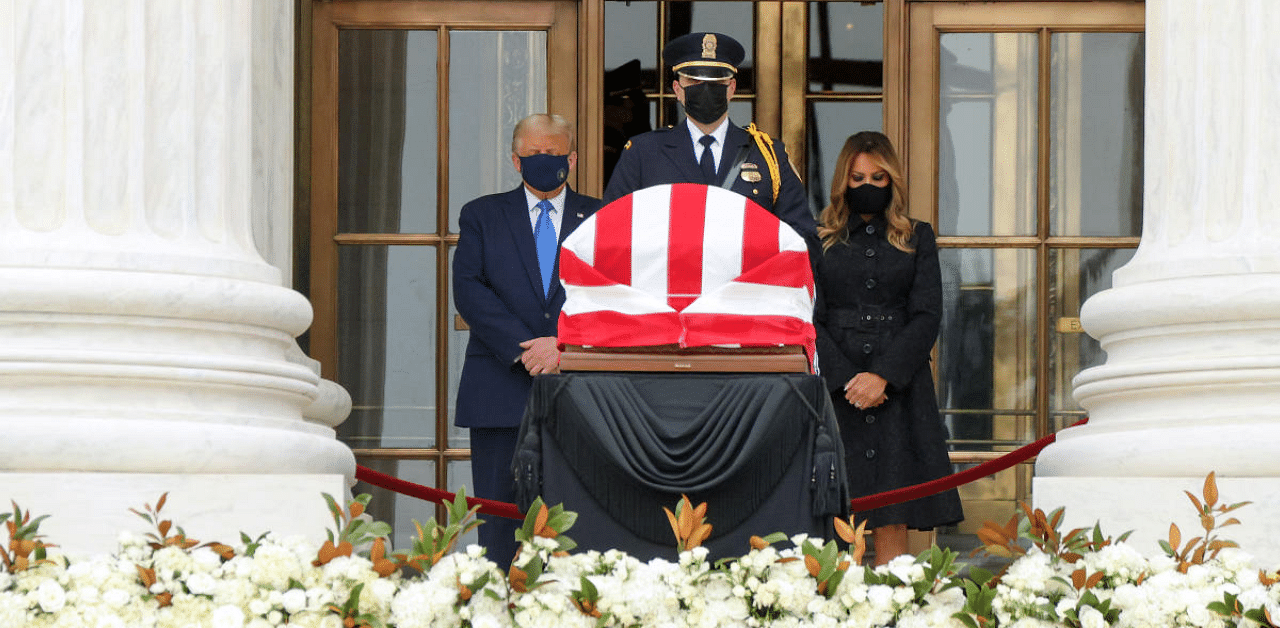 Trump, wearing a black face mask, and First Lady Melania Trump stood silently behind the flag-draped casket of the progressive justice who died last week. Credit: Reuters Photo