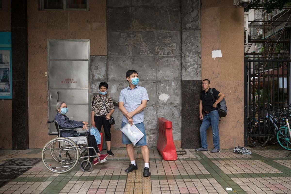 Jiang Weixing, left, is living in a building with a retrofitted elevator. Given her difficulties walking, she and her wheelchair had to be carried up and down the stairs until the elevator was built. The New York Times