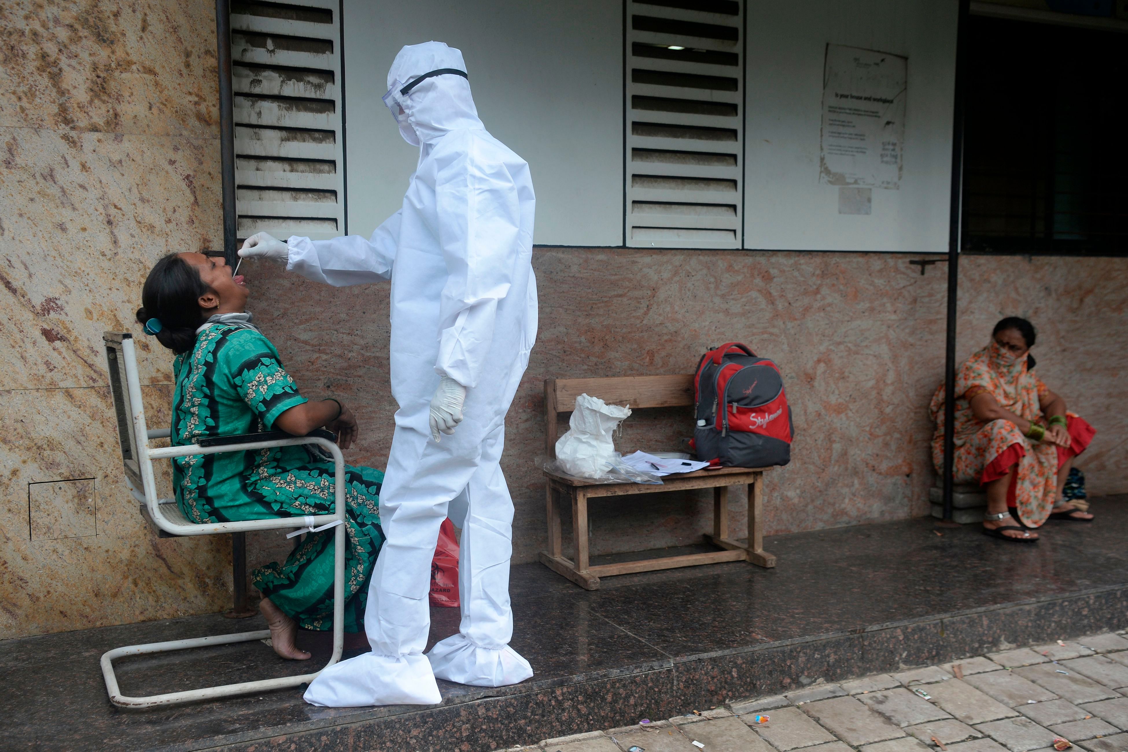 A health worker takes a throat swab during a Covid-19. Credits: AFP Photo