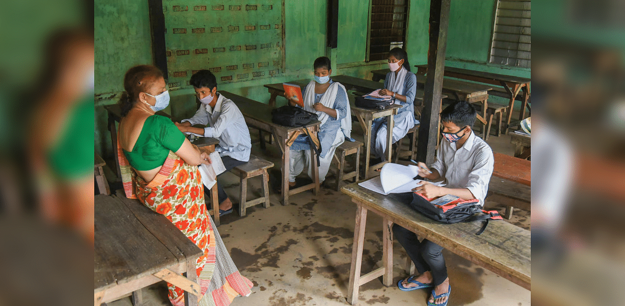 Students maintain social distancing as they attend a class, after schools and colleges re-opened in Assam during Unlock 4, in Guwahati, Monday, Sept. 21, 2020. Credit: PTI Photo
