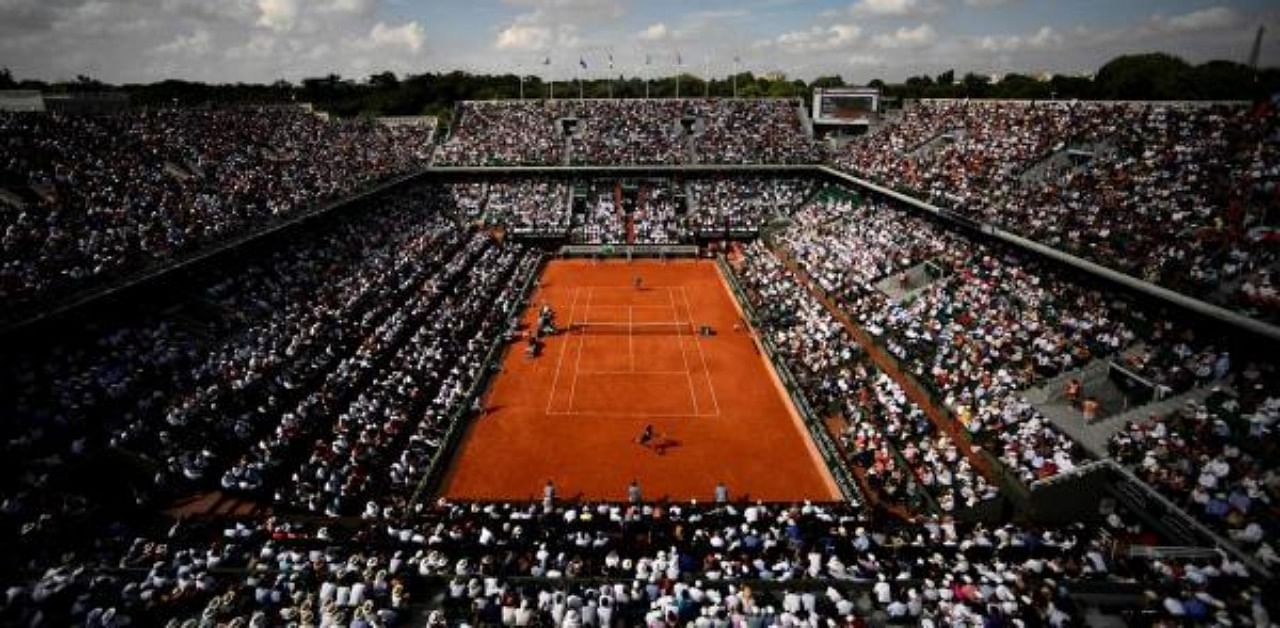 In this file photo taken on June 8, 2018 spectators watch Spain's Rafael Nadal (TOP) as he plays Argentina's Juan Martin del Potro during their men's singles semi-final match on day thirteen of The Roland Garros 2018 French Open tennis tournament in Paris. Credit: AFP Photo