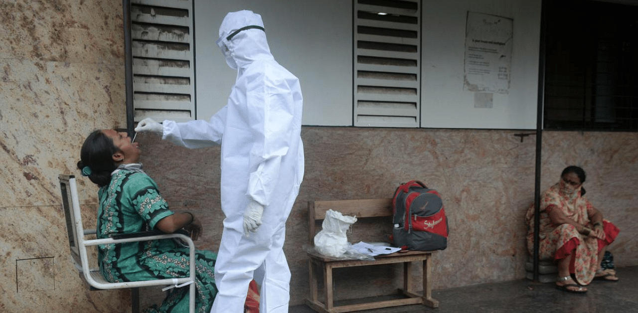 A health worker takes a throat swab during a Covid-19  screening in Mumbai. Credit: AFP