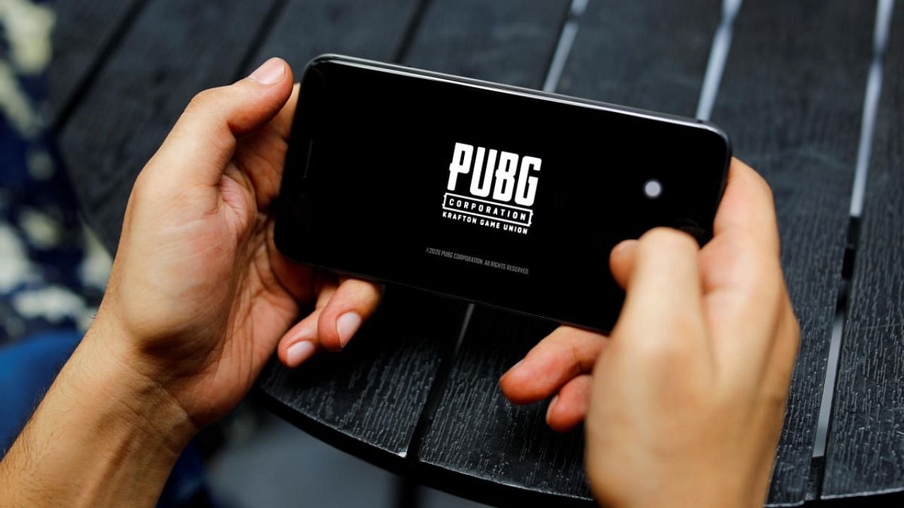 A boy plays Tencent Holdings' PUBG videogame on his mobile phone at a cafe in New Delhi. Credit: Reuters/file photo.