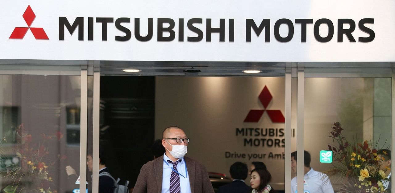 People visit a showroom at the headquarters of Mitsubishi Motors Corp in Tokyo. Credit: AP Photo