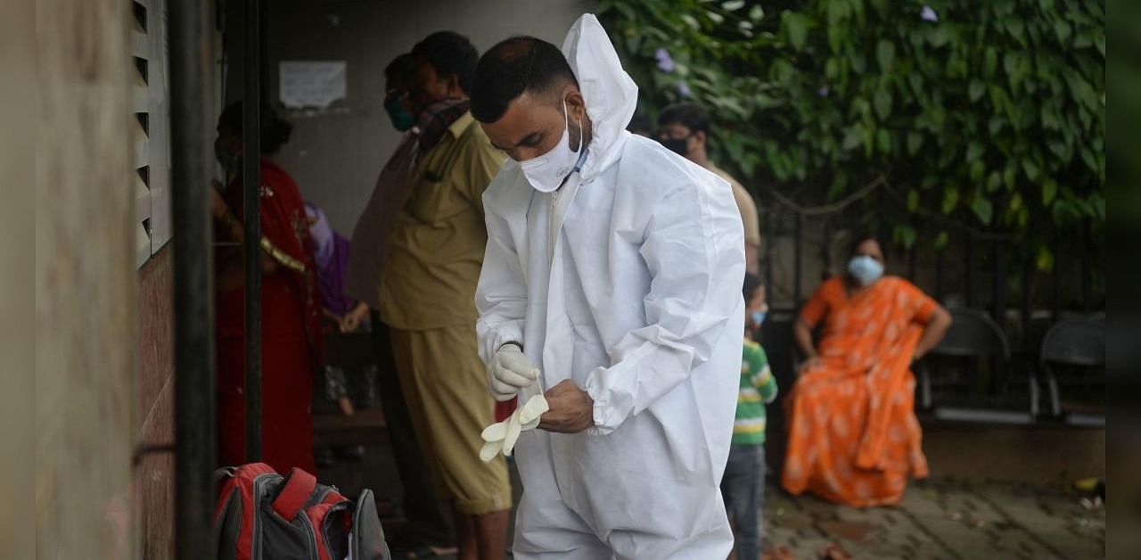A health worker gets ready to conduct Covid-19 Coronavirus swabs in Mumbai on September 25, 2020. Credit: AFP Photo