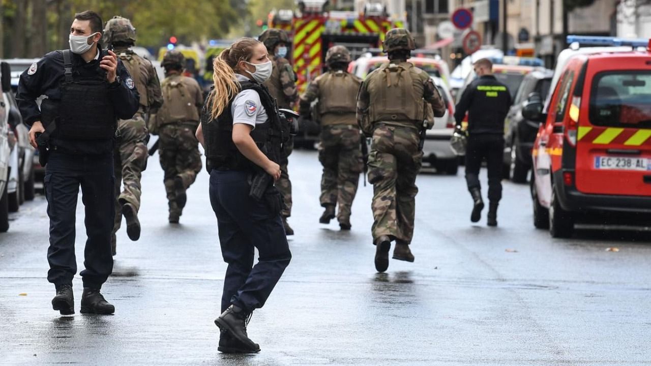 French army soldiers rush to the scene after several people were injured near the former offices of the French satirical magazine Charlie Hebdo following an alleged attack by a man wielding a knife in the capital Paris. Credit: AFP.