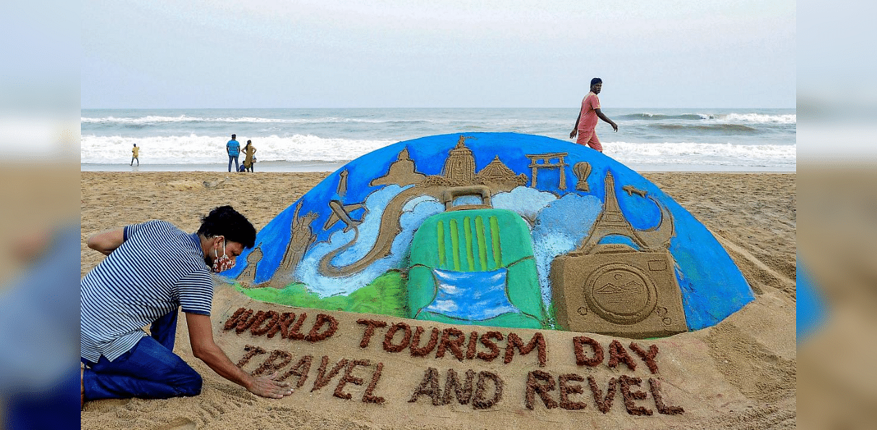 Sand artist Manas Sahoo makes a sand sculpture onthe eve of World Tourism Day, at Puri beach, Odisha, Saturday, Sept. 26, 2020. Credit: PTI Photo