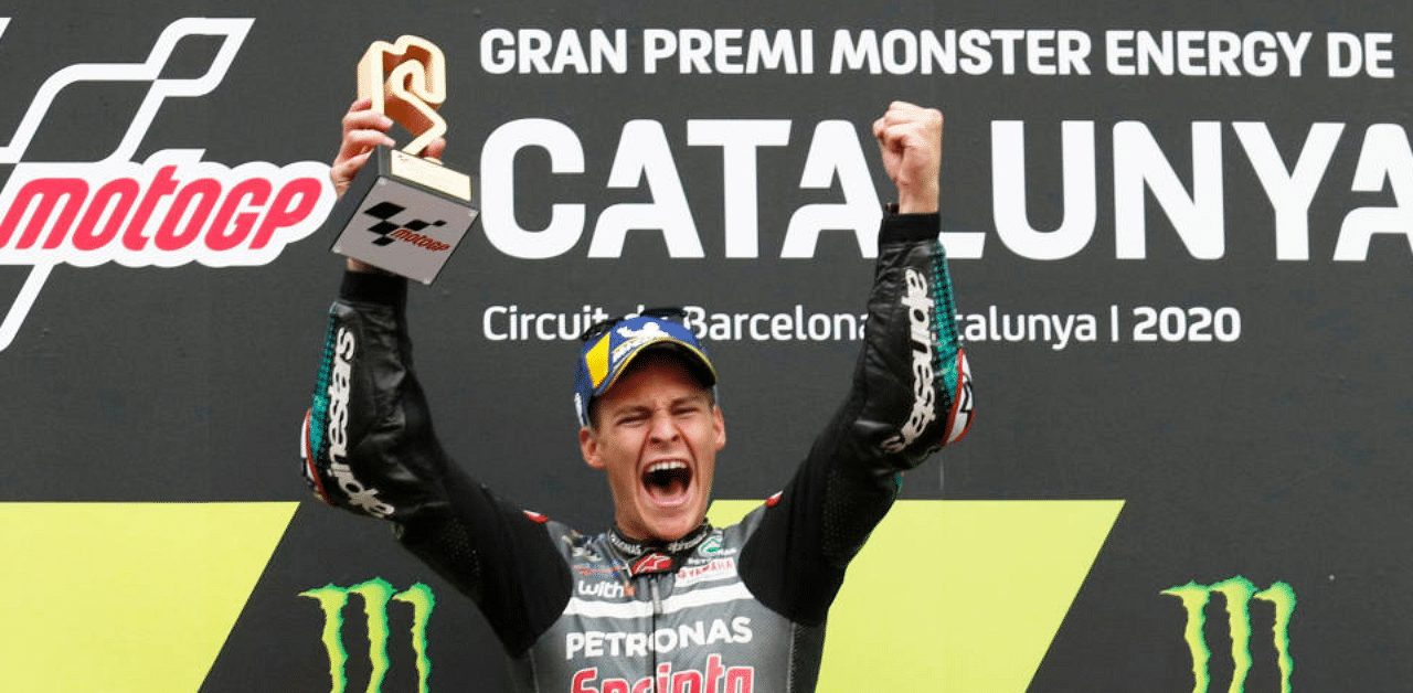Petronas Yamaha SRT's Fabio Quartararo celebrates with a trophy on the podium after winning the race. Credit: Reuters Photo