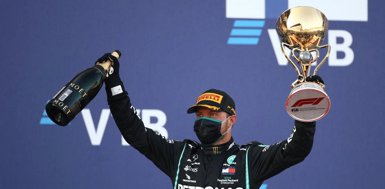 Mercedes' Finnish driver Valtteri Bottas celebrates on the podium after winning the Formula One Russian Grand Prix at the Sochi Autodrom Circuit in Sochi. Credit: AFP Photo