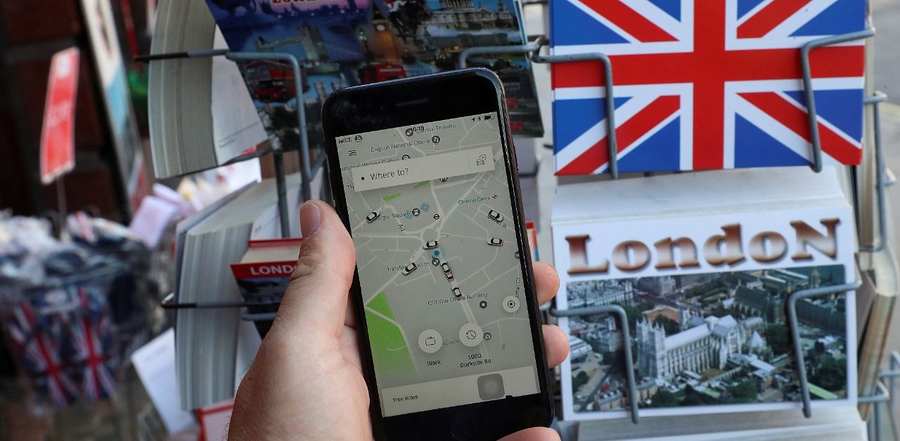 Uber app and London themed postcards in London. Credit: Reuters Photo