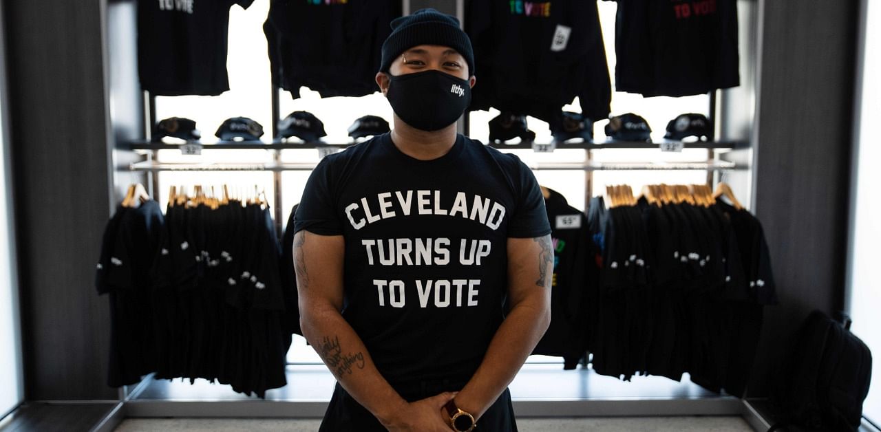“Cleveland Turns Up To Vote” shirts designed by local artist ,Glen Infante, hang at Rocket Mortgage Fieldhouse where a voter registration event took place on September 21, 2020 in Cleveland, Ohio. Credit: AFP Photo