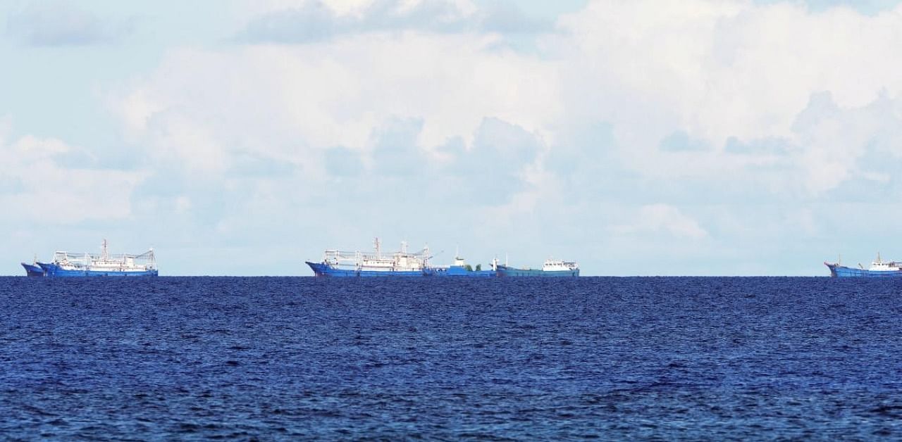 Chinese boats anchored near their-claimed reef, Subi, as seen from the Philippine-claimed island of Thitu. Credit: AFP