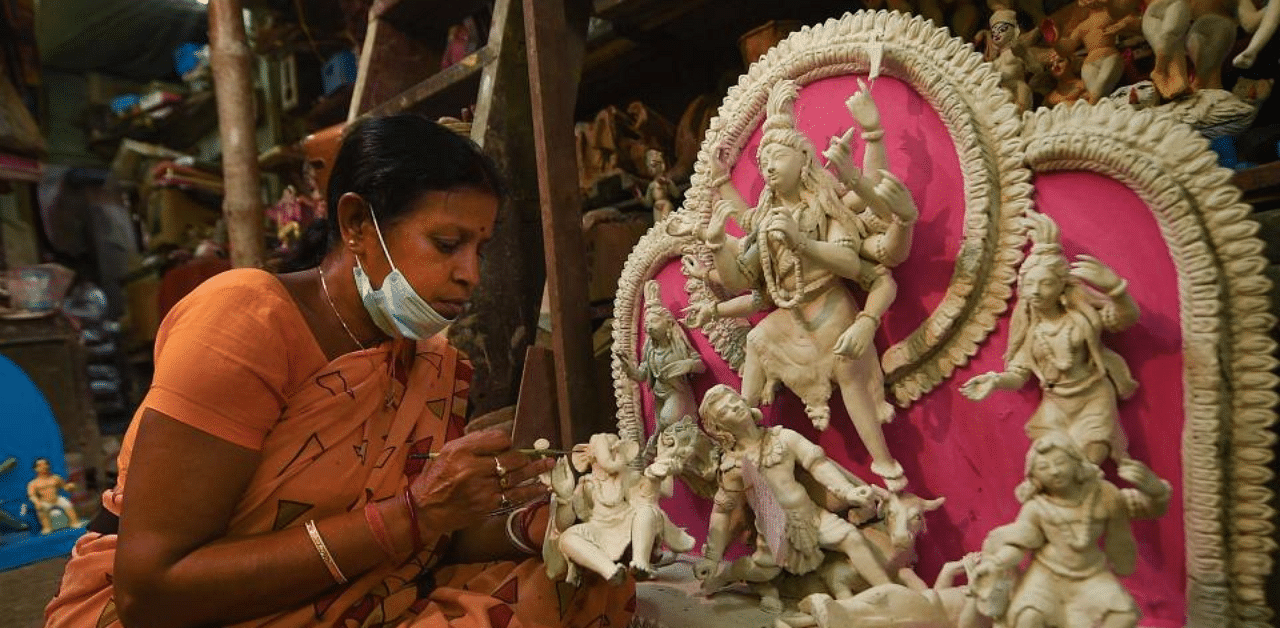 An artisan makes an idol of Goddess Durga for the upcoming Durga Puja festival, at Kumartuli in Kolkata, Sunday, Sept. 20, 2020. Credit: PTI Photo
