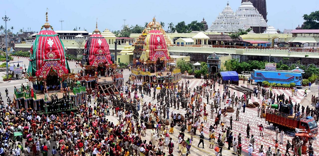 Ditties of Shree Jagannath temple and Hindu devotees wait to pull the three chariots (L) on the occasion of the annual Shree Jagannath chariot festival in Puri. Credit: AFP Photo