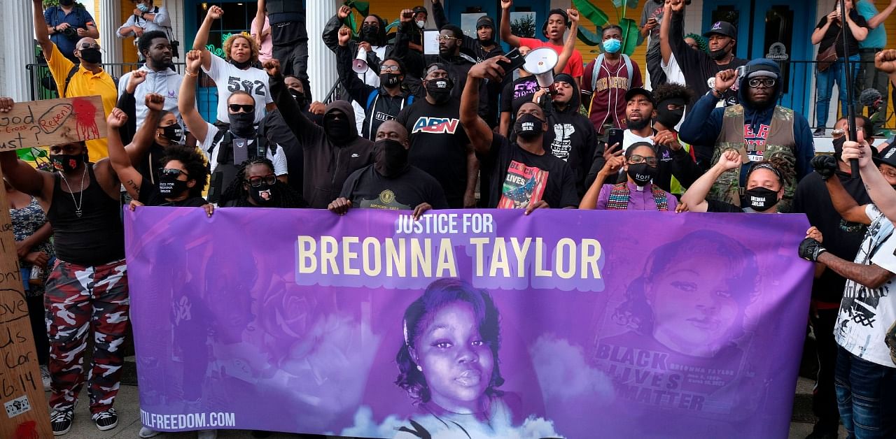 Demonstrators pose for a photo in front of a local restaurant in the NULU neighborhood on a third day of protest over the lack of criminal charges in the police killing of Breonna Taylor. Credit: AFP Photo