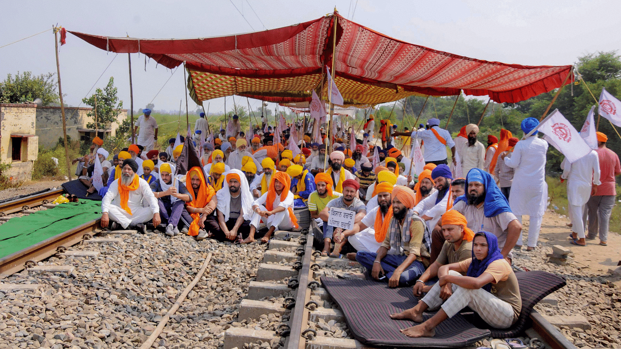 Farmers block railway tracks during their ongoing 'Rail Roko' or 'Stop the Trains' agitation. Credits: PTI Photo
