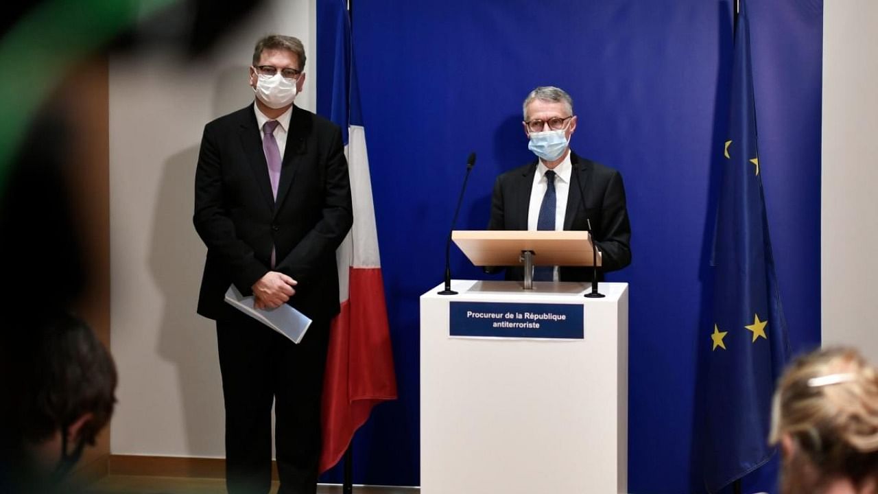 Anti-terrorism state prosecutor Jean-Francois Ricard (R) wearing a face mask speaks next to Christian Sainte Director of the Judicial Police during a press conference. Credit: AFP.
