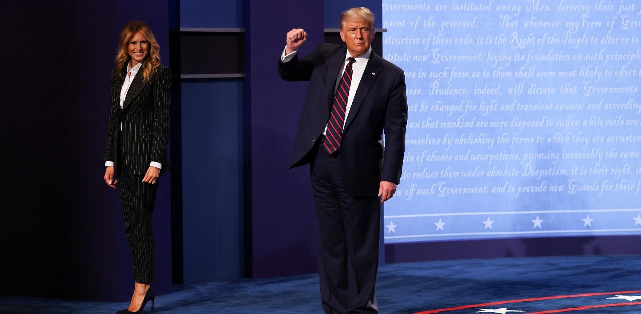 President Donald Trump thrusts his fist as he and first lady Melania Trump depart after his first 2020 campaign debate against Democratic presidential nominee Joe Biden. Credit: Reuters photo